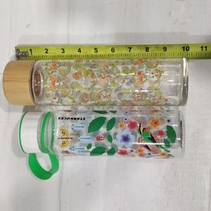 2 travel cups (1 Starbucks plastic, 1 glass w/ bamboo top)